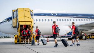 sports team boarding a flight